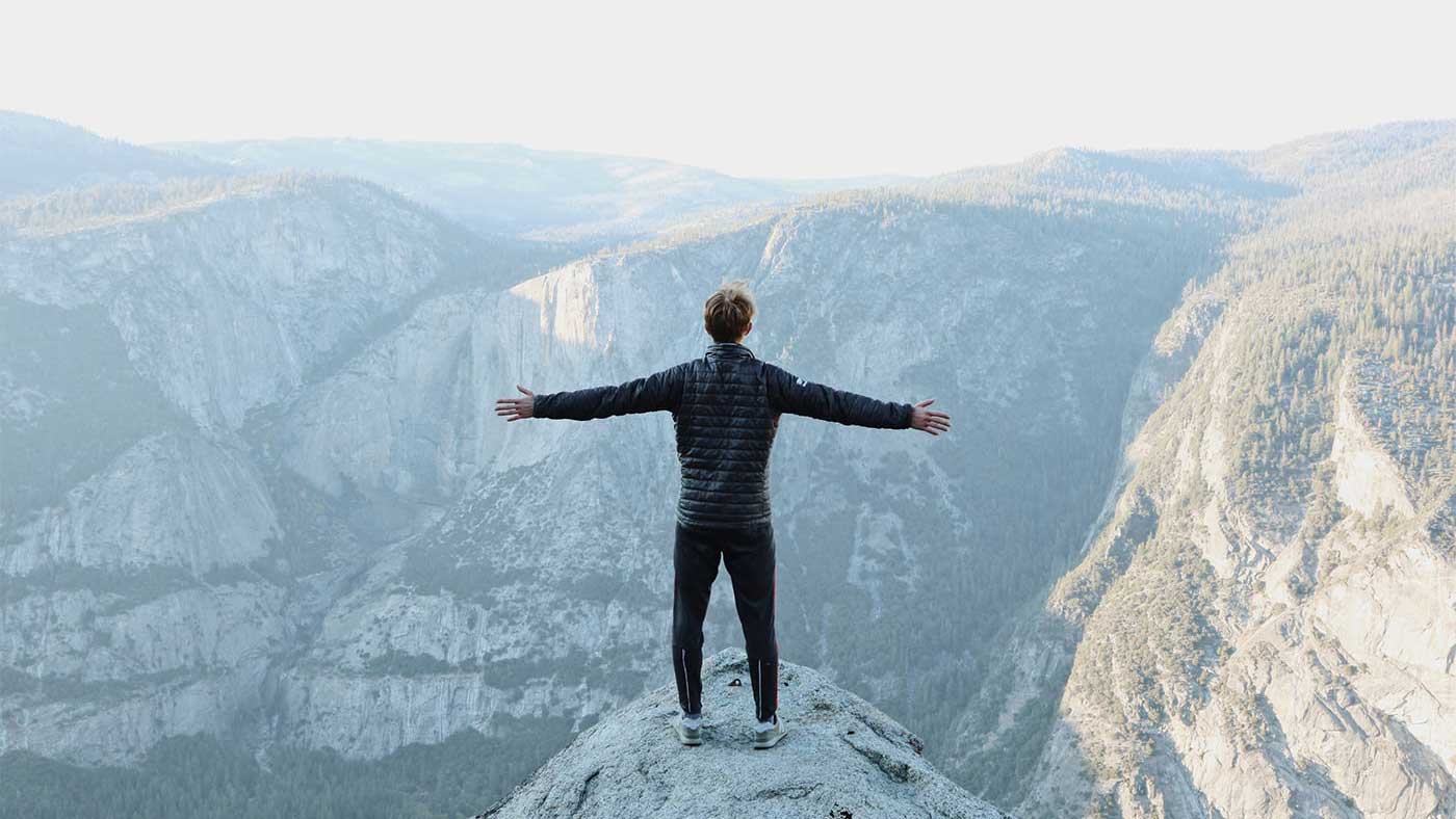 Man looking out on cliff